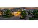 Charming two-story home with a well-manicured lawn, mature trees, and a paved driveway leading to a two-car garage at 696 Eveningsong Dr, Castle Rock, CO 80104