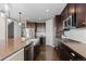 Modern kitchen with stainless steel appliances, dark cabinets, a spacious island, and plenty of counter space at 696 Eveningsong Dr, Castle Rock, CO 80104