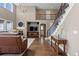 Elegant living room featuring a fireplace, entertainment center, staircase to the second floor and an abundance of natural light at 696 Eveningsong Dr, Castle Rock, CO 80104