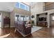 Comfortable living room with tall ceilings, large windows, a fireplace, and a stylish entertainment center at 696 Eveningsong Dr, Castle Rock, CO 80104