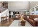 Open-concept living room with hardwood floors, a large sectional sofa, and seamless flow to the kitchen at 696 Eveningsong Dr, Castle Rock, CO 80104