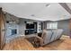 Cozy basement living room features a stone fireplace, entertainment center, and comfortable seating at 696 Eveningsong Dr, Castle Rock, CO 80104