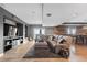 Spacious living room with tile floors, large sectional sofa, entertainment center, and accent lighting at 696 Eveningsong Dr, Castle Rock, CO 80104