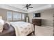 Spacious main bedroom with ceiling fan, dresser, and plush carpet at 696 Eveningsong Dr, Castle Rock, CO 80104