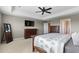 Comfortable main bedroom with neutral tones, ceiling fan and doorway to bath at 696 Eveningsong Dr, Castle Rock, CO 80104