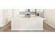 Kitchen island with white quartz countertop and stainless steel sink at 22260 E 8Th Pl, Aurora, CO 80018