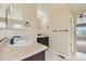 Bathroom with double sinks and dark brown vanity at 5353 Royal Pine St, Brighton, CO 80601
