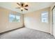 Well-lit bedroom with two windows and ceiling fan at 5353 Royal Pine St, Brighton, CO 80601