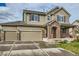 Two-story house with brick and siding, attached two-car garage, and landscaping at 5353 Royal Pine St, Brighton, CO 80601