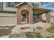 Brick front porch with a covered entryway, leading to the two-story house at 5353 Royal Pine St, Brighton, CO 80601