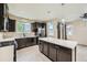 Spacious kitchen with dark wood cabinets, stainless steel appliances, and an island at 5353 Royal Pine St, Brighton, CO 80601