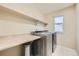 Laundry room with countertop space and storage shelves at 5353 Royal Pine St, Brighton, CO 80601