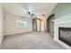 Bright living room featuring a fireplace and ample natural light at 5353 Royal Pine St, Brighton, CO 80601