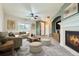 Spacious living room with fireplace, neutral carpeting, and large windows at 5353 Royal Pine St, Brighton, CO 80601