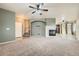 Open living space with a fireplace, high ceilings, and neutral tones at 5353 Royal Pine St, Brighton, CO 80601