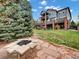 Expansive backyard with large deck, lush lawn, brick patio and fire pit, perfect for outdoor gatherings at 6533 S Quemoy Way, Aurora, CO 80016