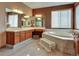 Spacious bathroom featuring a soaking tub, tiled floors, and a vanity with generous counter space and cabinetry at 6533 S Quemoy Way, Aurora, CO 80016