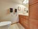 Well-maintained bathroom with wood cabinets, neutral color scheme, and essential fixtures for everyday comfort at 6533 S Quemoy Way, Aurora, CO 80016