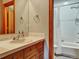 Bathroom features a wood vanity with sink and a tub and shower combination at 6533 S Quemoy Way, Aurora, CO 80016