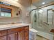 Well-lit bathroom with a glass-enclosed shower, a modern toilet, and a vanity with ample storage space at 6533 S Quemoy Way, Aurora, CO 80016
