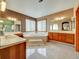 Expansive bathroom features a jetted tub, double vanities, and ample natural light at 6533 S Quemoy Way, Aurora, CO 80016