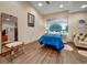 Bright bedroom with wave art, a plush chair, and dark wood-look flooring at 6533 S Quemoy Way, Aurora, CO 80016