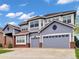 Beautiful two-story home with a three-car garage and a well-maintained lawn at 6533 S Quemoy Way, Aurora, CO 80016
