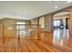 A grand foyer with gleaming hardwood floors, archways, and a view of the staircase at 6533 S Quemoy Way, Aurora, CO 80016