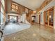 Grand foyer with a winding staircase, chandelier, and stone floors transitioning to carpet at 6533 S Quemoy Way, Aurora, CO 80016