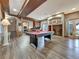 Spacious game room with a billiard table, wet bar, fireplace, and walk-out access at 6533 S Quemoy Way, Aurora, CO 80016