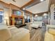Open living room features a cozy fireplace, large windows, and adjacent dining area at 6533 S Quemoy Way, Aurora, CO 80016