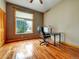 Office features hardwood floors, a large window, and plenty of room for a desk at 6533 S Quemoy Way, Aurora, CO 80016