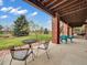 Covered patio with outdoor seating and a view of the spacious backyard at 6533 S Quemoy Way, Aurora, CO 80016