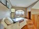 Cozy sitting room with a large window, comfortable seating, and hardwood floors at 6533 S Quemoy Way, Aurora, CO 80016