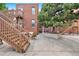 Large backyard featuring wooden stairs, a beautiful tree, and a concrete patio area at 122 N Logan St, Denver, CO 80203