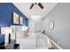 Bright bedroom featuring a ceiling fan, a skylight, and stylish, comfortable furniture at 122 N Logan St, Denver, CO 80203