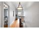 Well-lit hallway featuring hardwood floors and a stylish pendant light fixture at 122 N Logan St, Denver, CO 80203