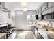 Well-lit kitchen with granite countertops, stainless steel appliances, and ample cabinet space at 122 N Logan St, Denver, CO 80203