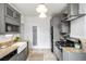 Modern kitchen featuring sleek cabinetry, granite countertops, stainless steel appliances and tile floors at 122 N Logan St, Denver, CO 80203