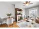 Inviting living room featuring a decorative fireplace, wood floors, ceiling fan, and a bright sitting area at 122 N Logan St, Denver, CO 80203