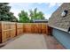 Fenced backyard with patio area, wooden fence, and greenery at 20 Scott Dr, Broomfield, CO 80020