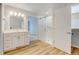 Bathroom with glass door walk in shower, closet with door and modern cabinets at 20 Scott Dr, Broomfield, CO 80020