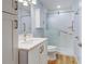 Bathroom featuring a white vanity with a quartz countertop and a glass-enclosed shower with safety bars at 20 Scott Dr, Broomfield, CO 80020
