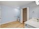 Bathroom with modern sink and cabinet, toilet, and closet with doors at 20 Scott Dr, Broomfield, CO 80020