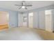 Large, light-filled bedroom features neutral walls, carpet, and two door closets at 20 Scott Dr, Broomfield, CO 80020