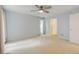 Large, light-filled bedroom features neutral walls, carpet, and a contemporary ceiling fan at 20 Scott Dr, Broomfield, CO 80020