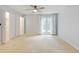 Large, light-filled bedroom features neutral walls, carpet, and closets with doors at 20 Scott Dr, Broomfield, CO 80020