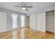 Well-lit bedroom with hardwood floors, ceiling fan, and closet with folding doors at 20 Scott Dr, Broomfield, CO 80020