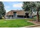 Unique two-story home with blue siding, brown roof, and well-manicured front lawn at 20 Scott Dr, Broomfield, CO 80020