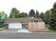 Exterior view of home featuring a large garage, landscaped yard, and peaked roof at 20 Scott Dr, Broomfield, CO 80020